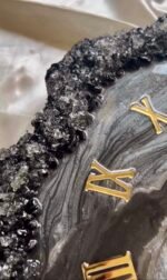 Crystal geode edge detailing on handmade black resin wall clock
