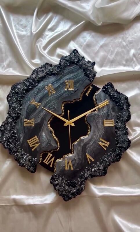 Front view of handmade black resin wall clock with glossy geode finish
