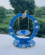 Blue handcrafted resin Laddu Gopal Ji jhula with peacock and floral decorations