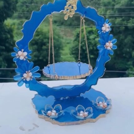 Handcrafted blue resin Laddu Gopal Ji jhula with floral and pearl detailing