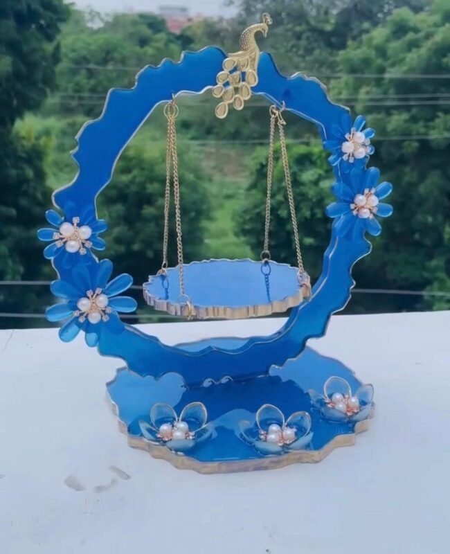 Handcrafted blue resin Laddu Gopal Ji jhula with floral and pearl detailing