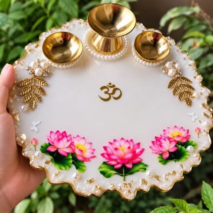 Handcrafted lotus resin pooja thali with pink flowers and brass diyas