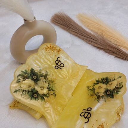 Handcrafted resin Sikh Khanda decor with yellow floral design and gold accents