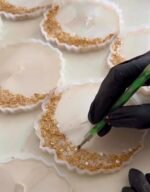 Artisan creating personalized handmade resin keepsake using premium resin and gold leaf detailing.