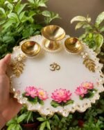 Lotus resin pooja thali with three brass diyas and Om symbol