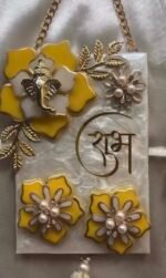 Close-up of handmade resin Shubh Labh wall hanging featuring Lord Ganesha, floral embellishments and premium pearl finish.